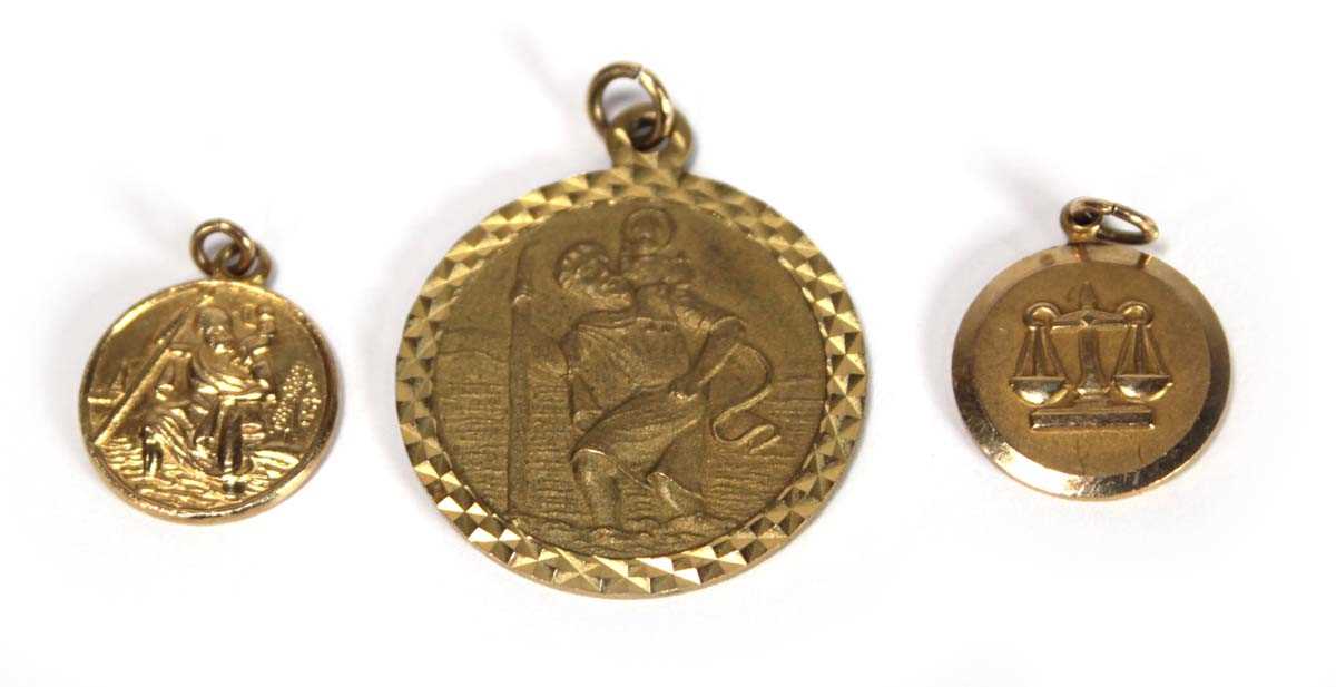 Lot 616 - Three 9ct yellow gold pendants comprising two...