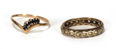 Lot 618 - A 9ct yellow gold v-shaped ring set four small...