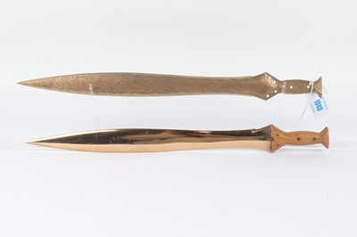 Lot 1040 - Two cast brass sidearms in the form of...