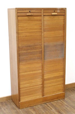 Lot 1 - A 1950/60's oak double-tambour cabinet with...
