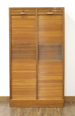 Lot 1 - A 1950/60's oak double-tambour cabinet with...
