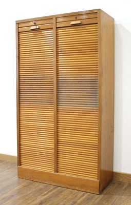 Lot 1 - A 1950/60's oak double-tambour cabinet with...