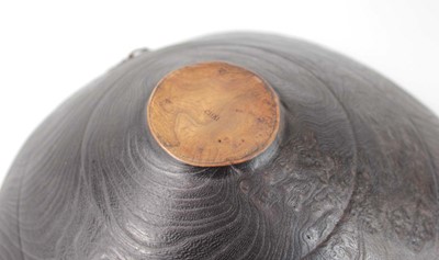 Lot 89 - A turned wooden bowl with leather straps by...