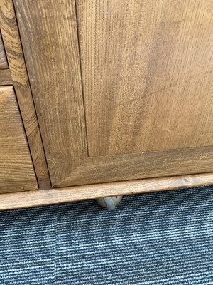 Lot 61 - An Ercol elm Windsor Range sideboard, the...