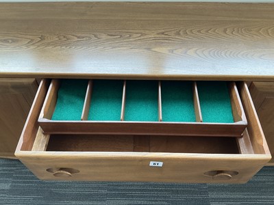 Lot 61 - An Ercol elm Windsor Range sideboard, the...