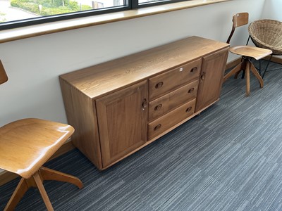 Lot 61 - An Ercol elm Windsor Range sideboard, the...