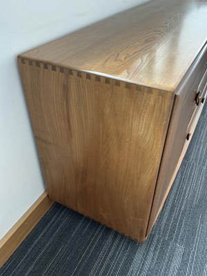 Lot 61 - An Ercol elm Windsor Range sideboard, the...