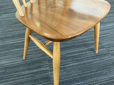 Lot 64 - An Ercol elm drop-leaf dining table on beech...