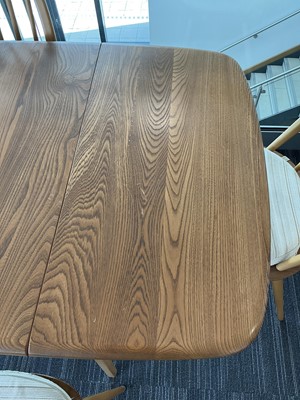Lot 64 - An Ercol elm drop-leaf dining table on beech...