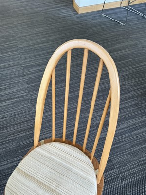 Lot 64 - An Ercol elm drop-leaf dining table on beech...