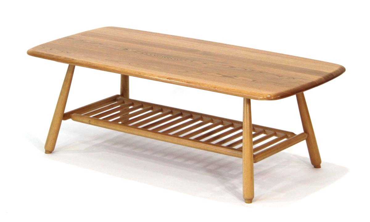 Lot 66 - An Ercol elm coffee table of cushioned...