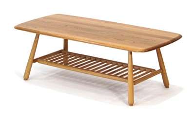 Lot 66 - An Ercol elm coffee table of cushioned...