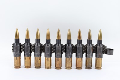 Lot 2587 - Nine Russian 14.5mm drill cartridges in belt
