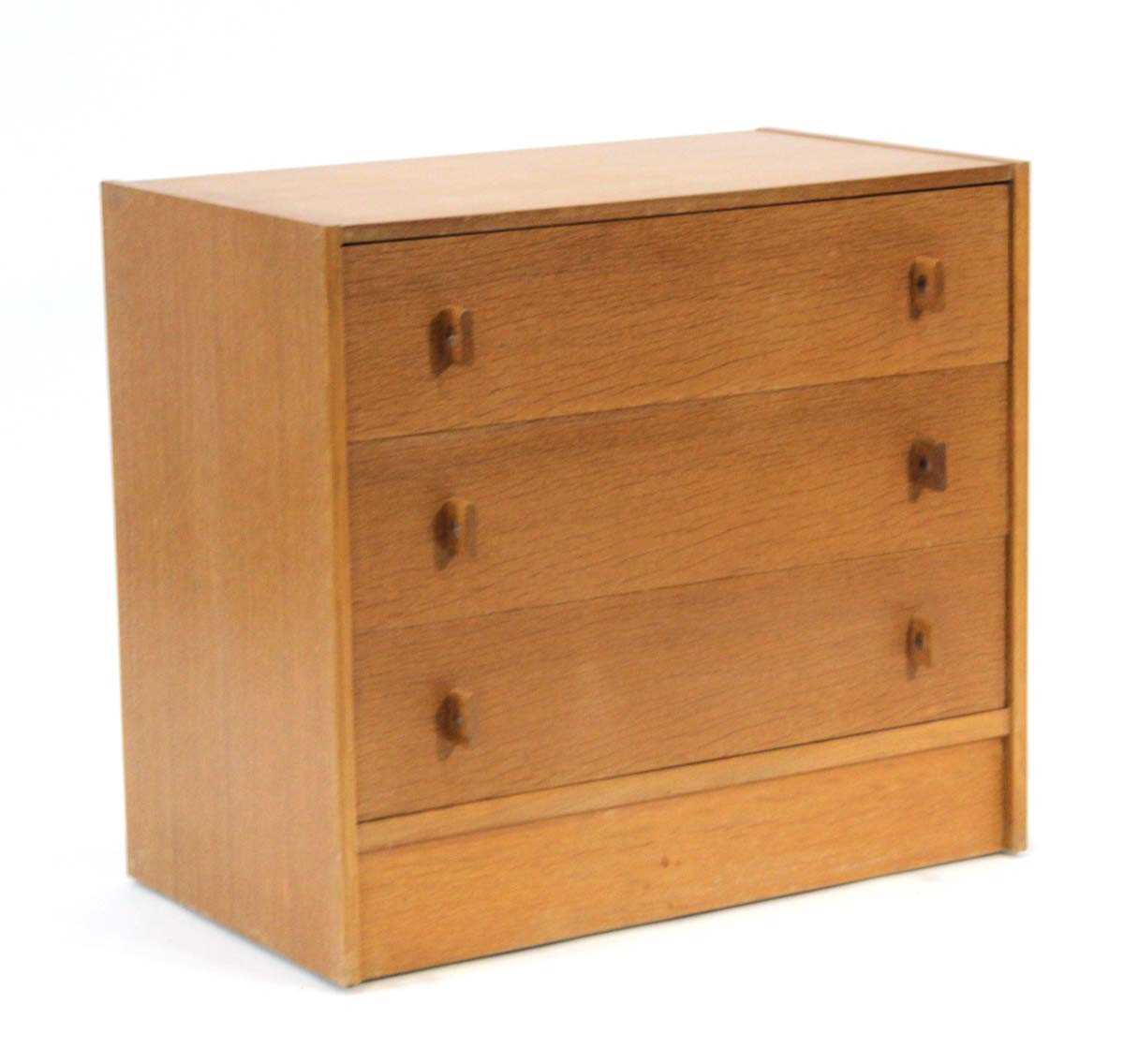 Lot 45 - A 1960's oak chest of four drawers on a plinth...