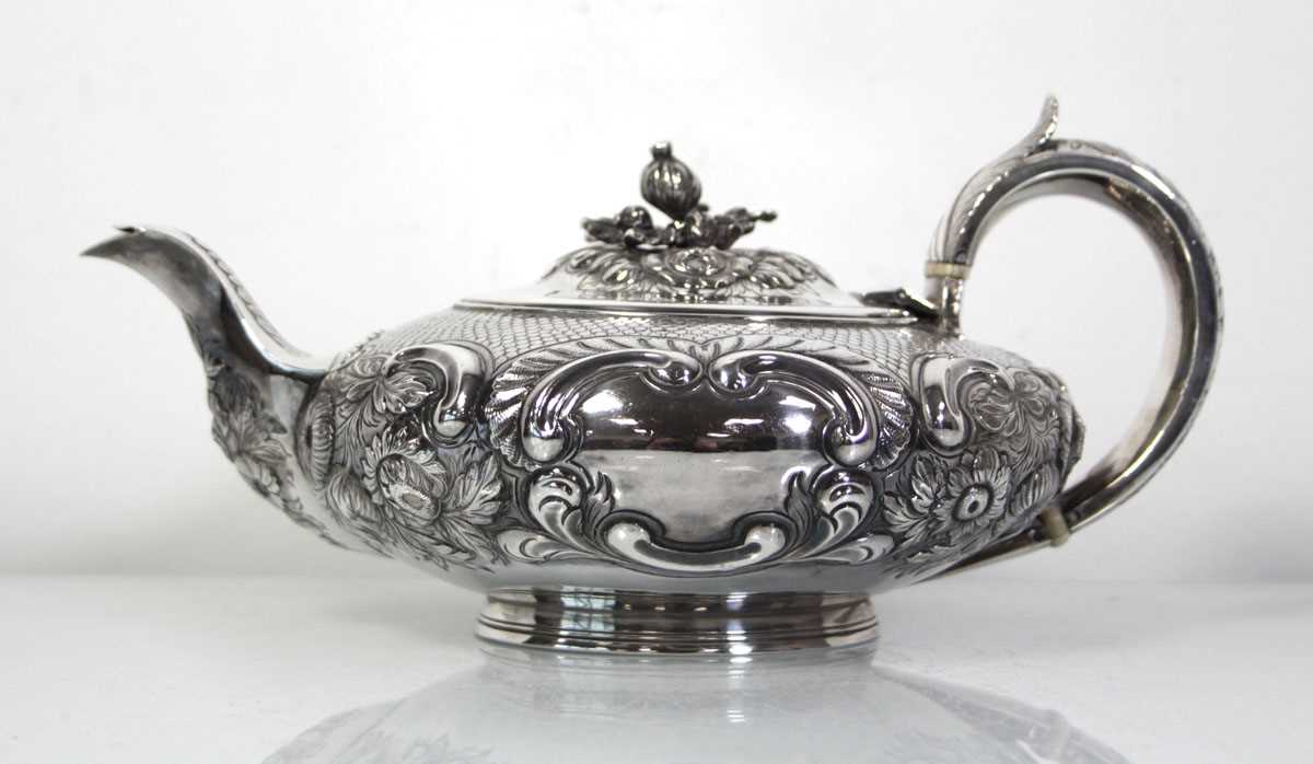 Lot 200 - A Regency silver teapot of squat form with...