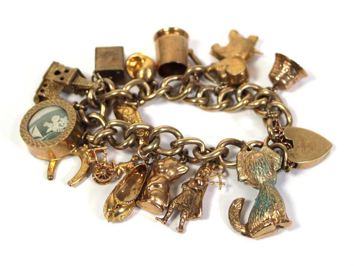 Lot 621 - A 9ct yellow gold curblink bracelet with heart...