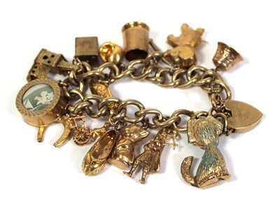 Lot 621 - A 9ct yellow gold curblink bracelet with heart...