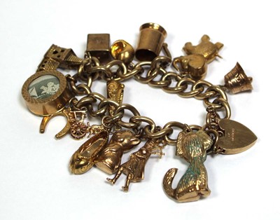Lot 621 - A 9ct yellow gold curblink bracelet with heart...