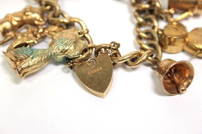 Lot 621 - A 9ct yellow gold curblink bracelet with heart...