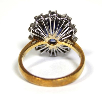 Lot 622 - An 18ct yellow gold cluster ring set oval blue...