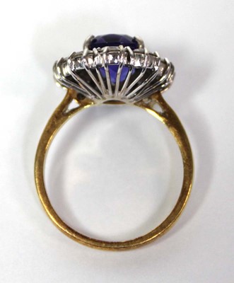 Lot 622 - An 18ct yellow gold cluster ring set oval blue...