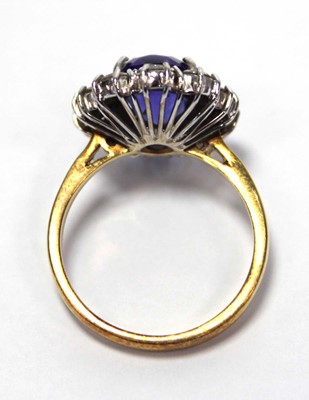 Lot 622 - An 18ct yellow gold cluster ring set oval blue...