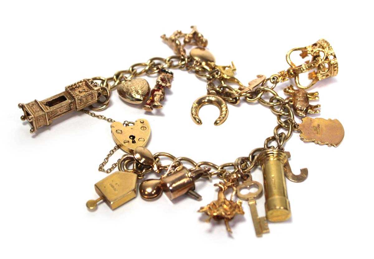 Lot 628 - A 9ct yellow gold curblink bracelet with heart...