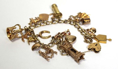 Lot 628 - A 9ct yellow gold curblink bracelet with heart...