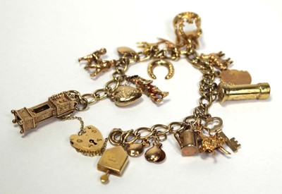 Lot 628 - A 9ct yellow gold curblink bracelet with heart...