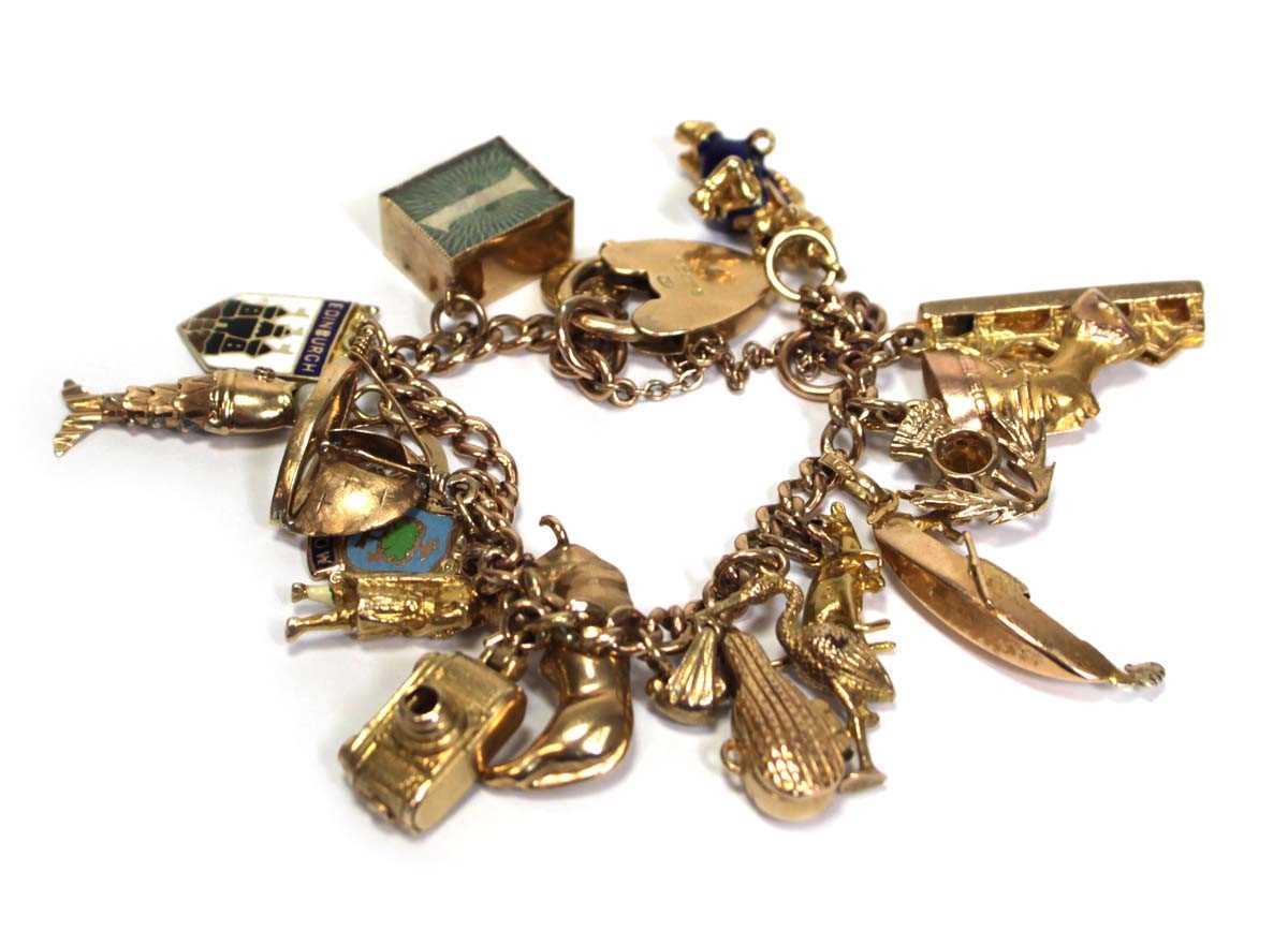 Lot 629 - A 9ct yellow gold curblink bracelet with heart...