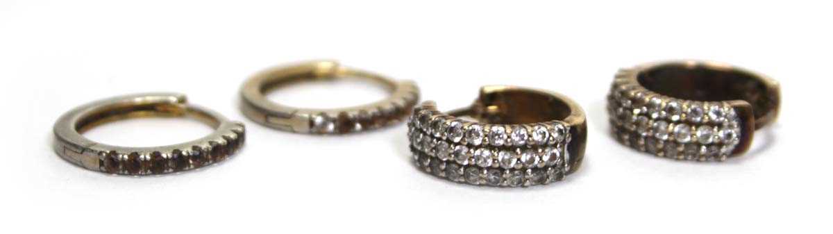 Lot 635 - A pair of 9ct yellow gold ear hoops set paste,...