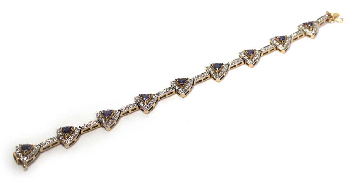 Lot 636 - A 14ct yellow gold bracelet set nine sections,...