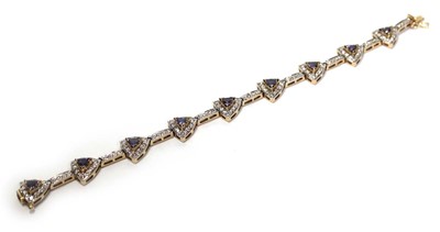 Lot 636 - A 14ct yellow gold bracelet set nine sections,...