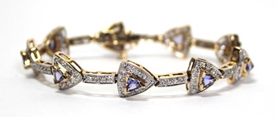 Lot 636 - A 14ct yellow gold bracelet set nine sections,...