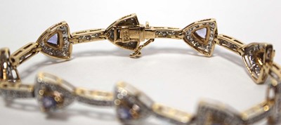 Lot 636 - A 14ct yellow gold bracelet set nine sections,...