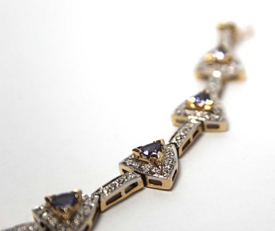 Lot 636 - A 14ct yellow gold bracelet set nine sections,...