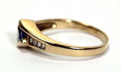 Lot 638 - A 14ct yellow gold ring set a trillion cut...