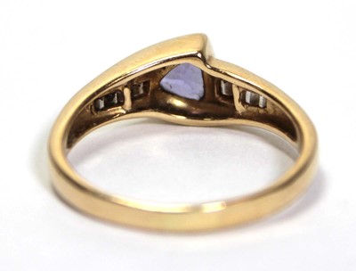 Lot 638 - A 14ct yellow gold ring set a trillion cut...