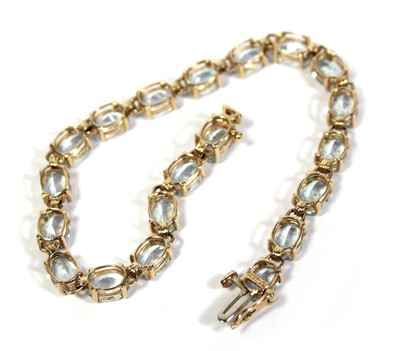 Lot 642 - A 14ct yellow gold tennis type bracelet set...