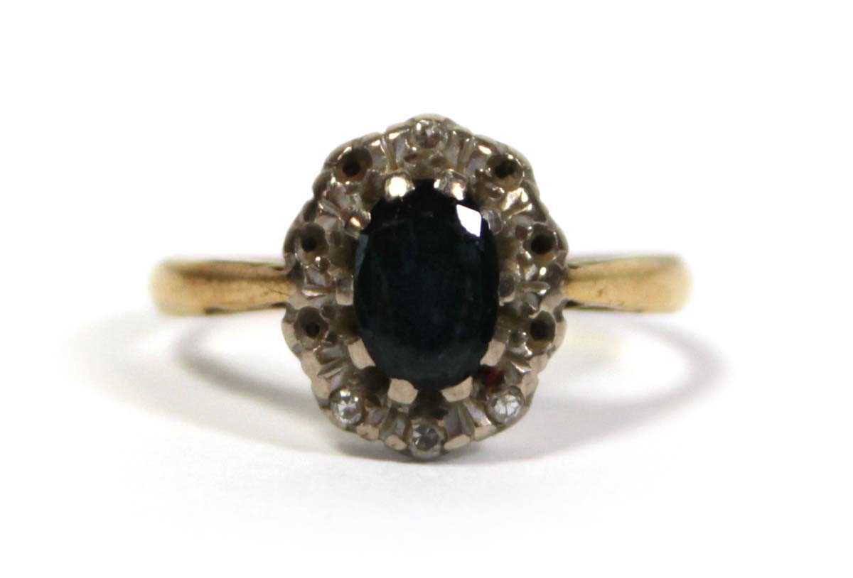 Lot 643 - An 18ct yellow gold cluster ring set oval...