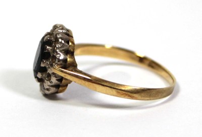 Lot 643 - An 18ct yellow gold cluster ring set oval...