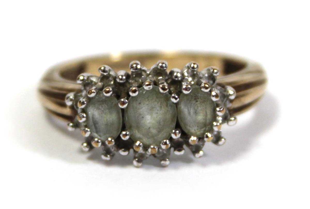 Lot 644 - A 9ct yellow gold ring set three graduated...