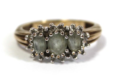 Lot 644 - A 9ct yellow gold ring set three graduated...