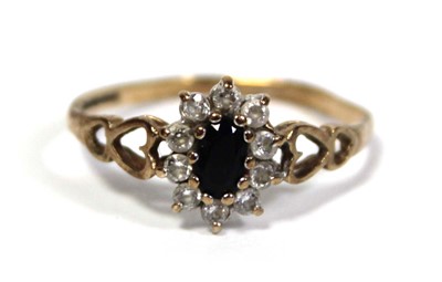 Lot 645 - A 9ct yellow gold cluster ring set oval...