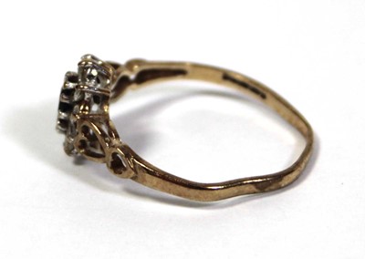 Lot 645 - A 9ct yellow gold cluster ring set oval...