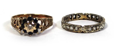 Lot 647 - A 9ct yellow gold cluster ring set diamond and...