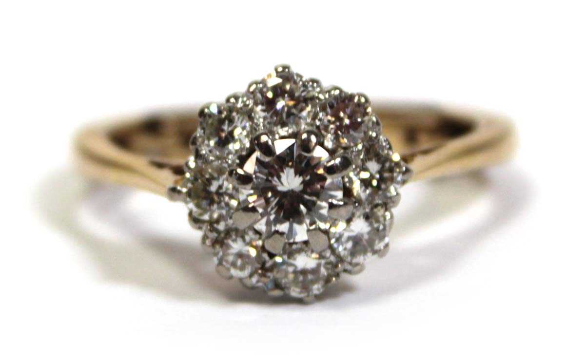 Lot 649 - A 9ct yellow gold cluster ring set brilliant...