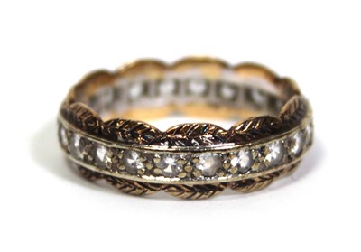 Lot 650 - A 9ct two-colour gold eternity ring set paste...