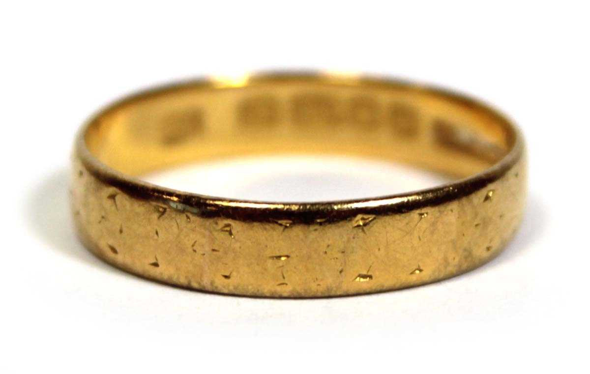 Lot 651 - A 22ct yellow gold wedding band, London 1956,...
