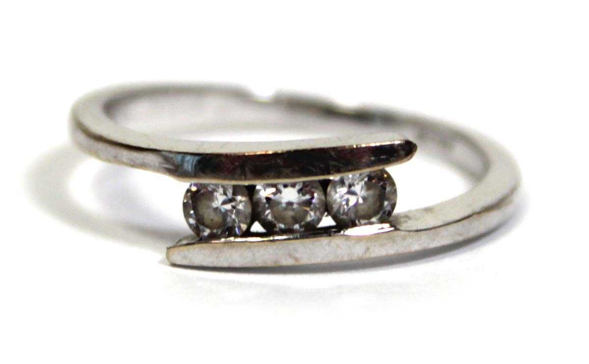 Lot 652 - An 18ct white gold ring set three clear paste...